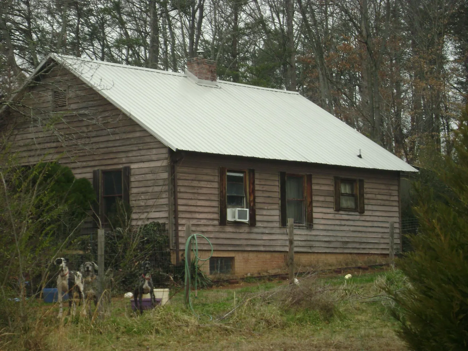 White metal roof on an old wood sided farmhouse, from a Metal Roof Installation job in White Mills